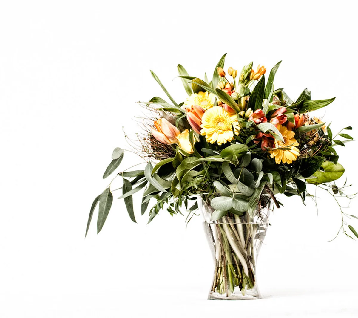 A large mixed bouquet arranged in a clear glass vase