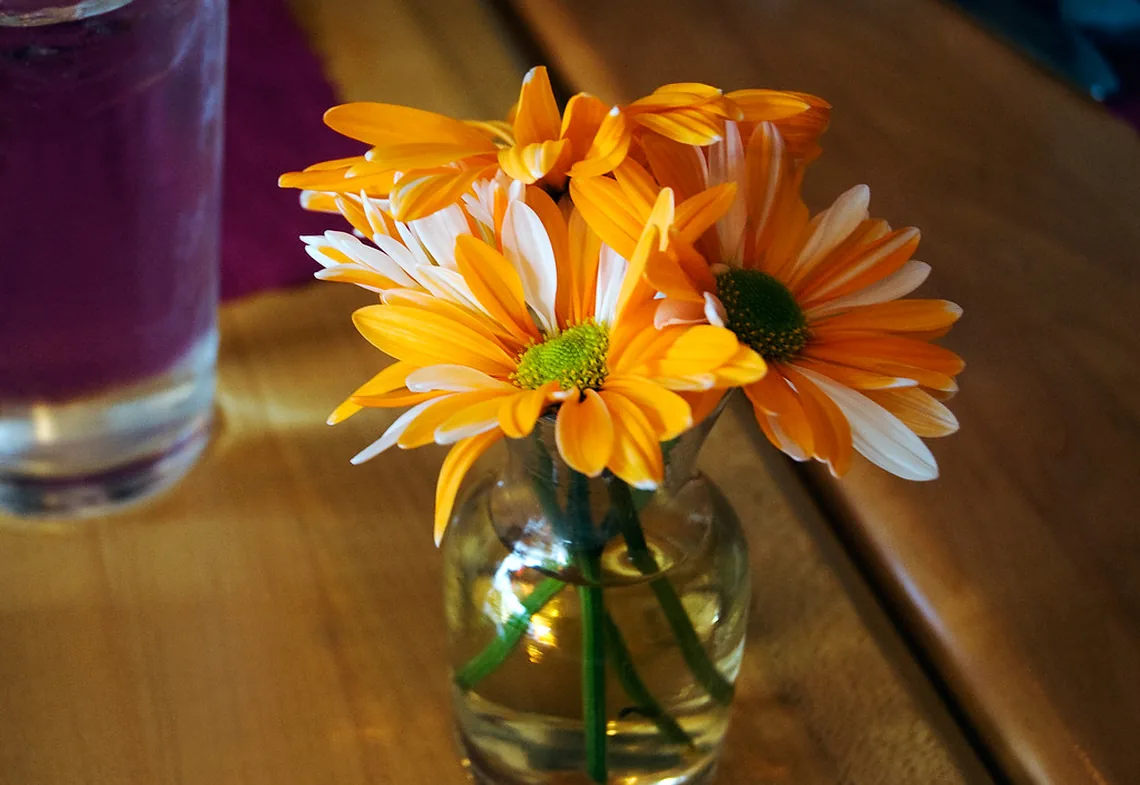 Orange gerberas arranged in a clear glass jar